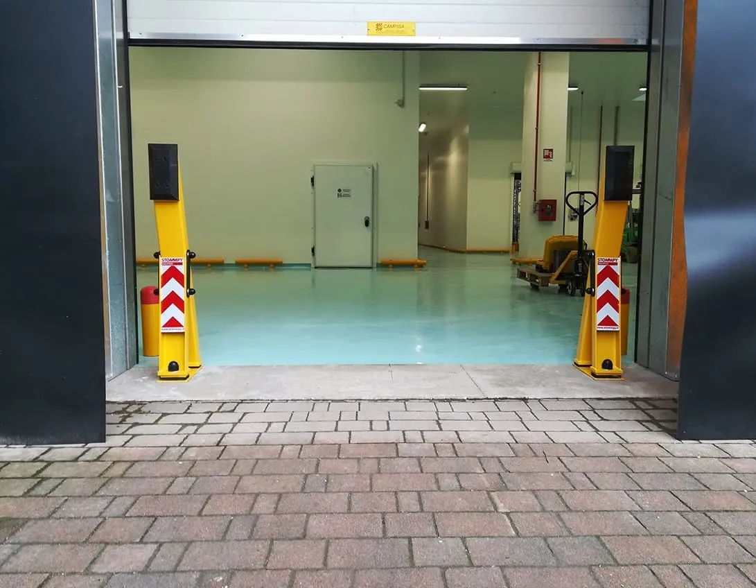 Loading dock doorway with impact posts and chevron markings either side