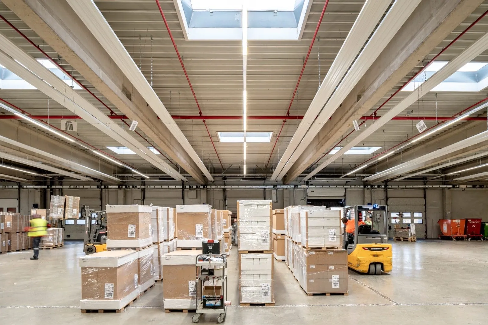 Warehouse with radiant heating strips running the length of the ceiling above the pallet aisles