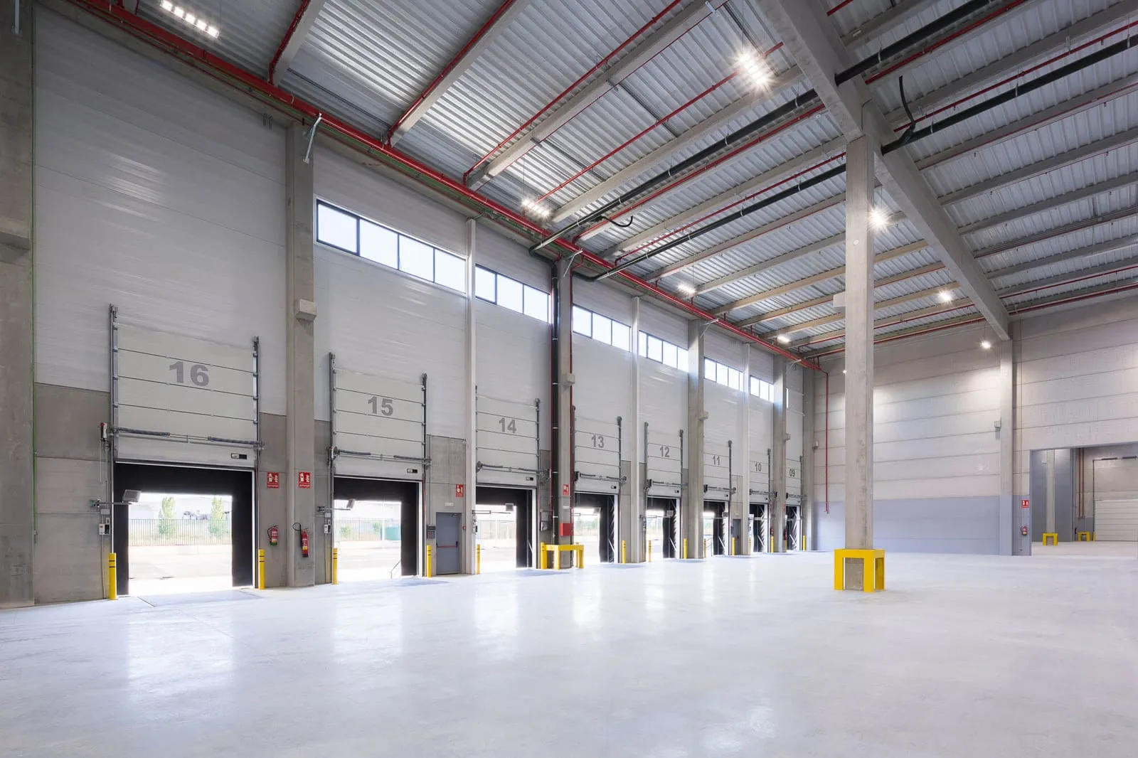 High bay LED fittings lighting the aisles of an industrial building