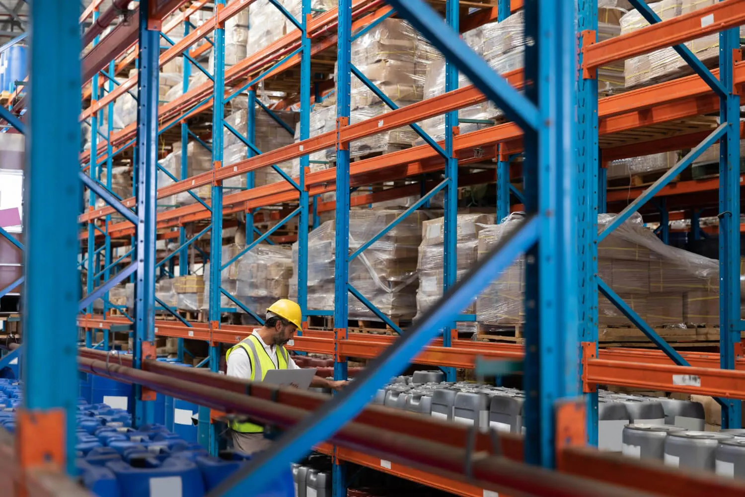 Technician tightening fixings on a racking frame during a maintenance visit