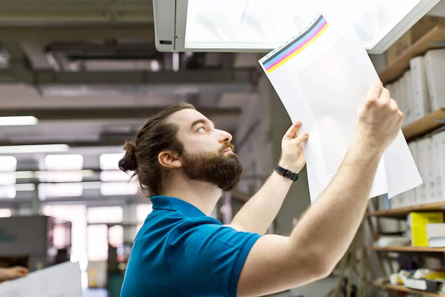 Printer checking a colour proof of warehouse rack and aisle labels