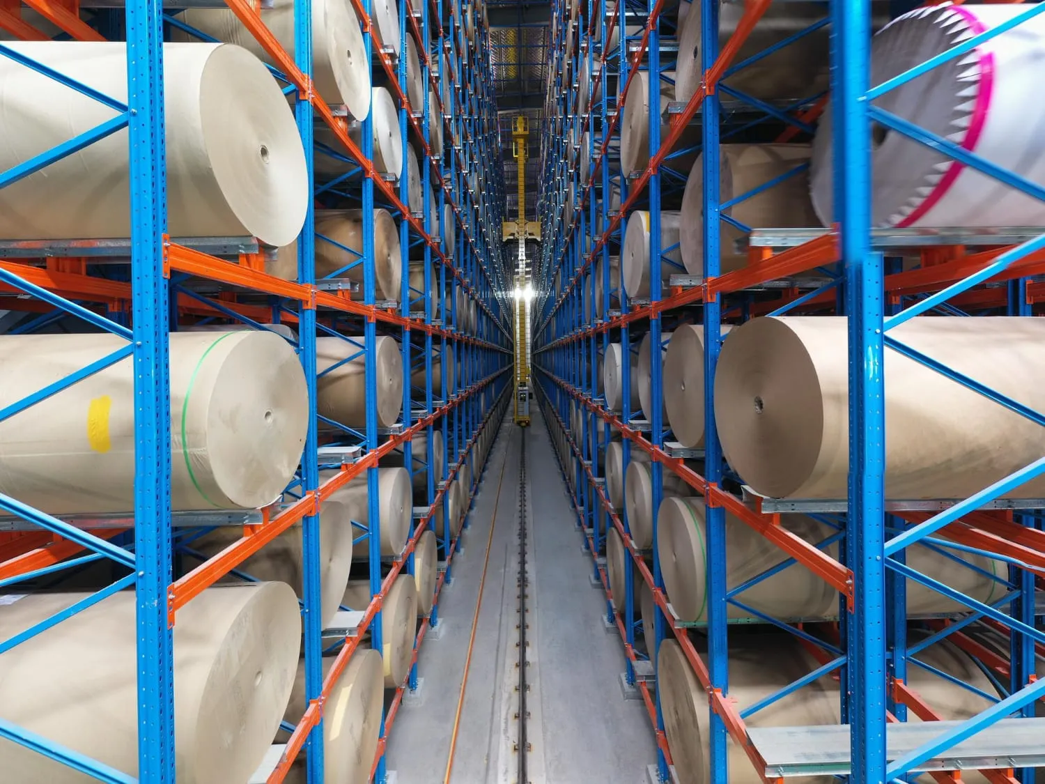 Steel coils resting in shaped cradles on a coil racking system