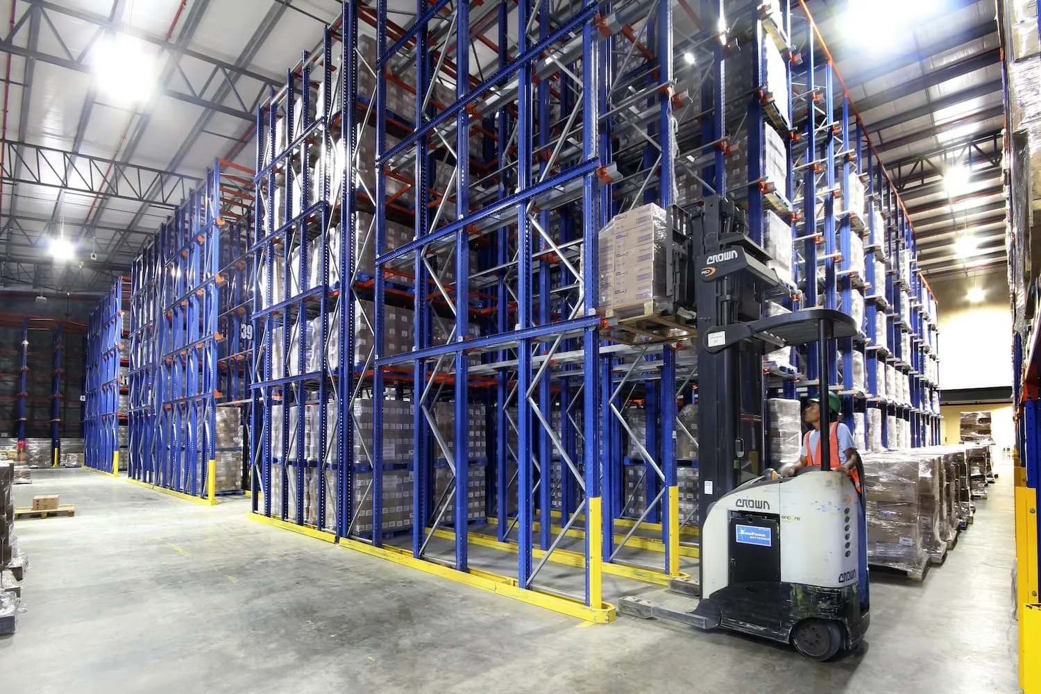 Drive-in racking lanes with a forklift entering between the uprights