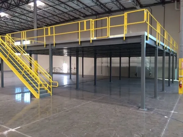 Free-standing steel mezzanine on its own columns inside a warehouse