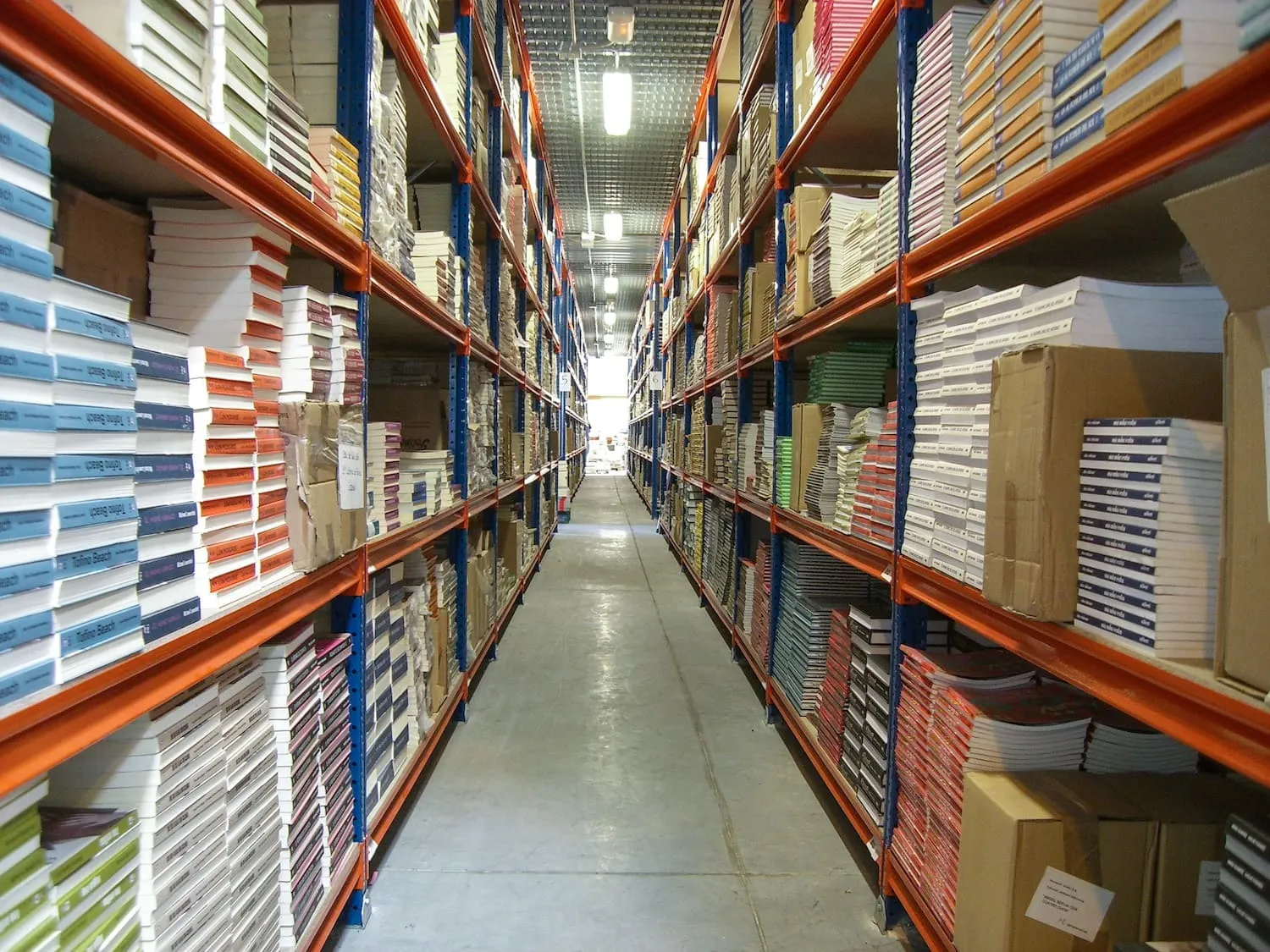 Multi-level picking shelving stocked with cartons and small parts