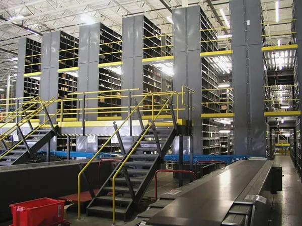 Picking mezzanine carried by small parts shelving with a walkway between the aisles